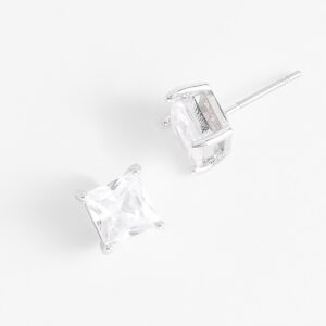 Aretes de botón con diamonice transparente en baño de rodio.